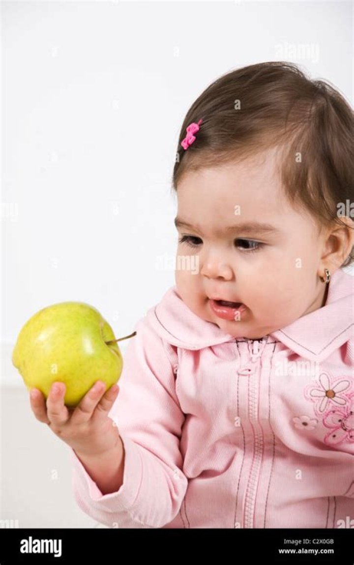 Baby's Arm Holding An Apple